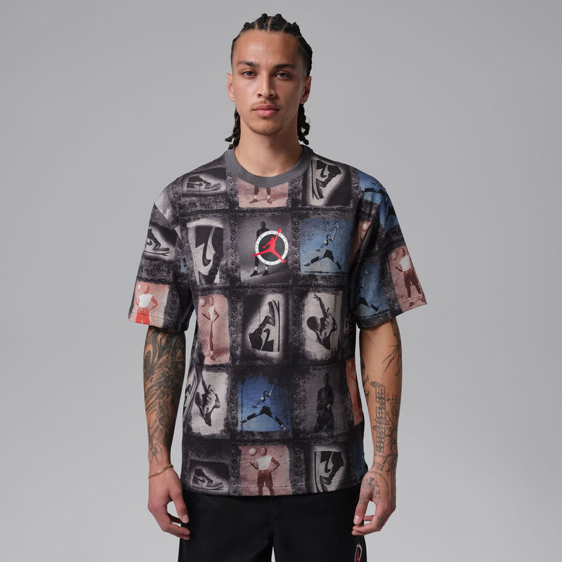 Men's graphic T-shirt front view, dark collage print with short sleeves and red logo at center