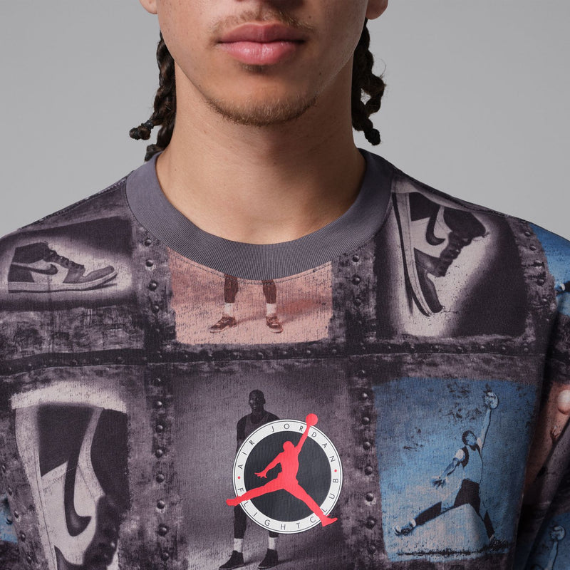 Men's graphic T-shirt close-up: dark collage print with blue and red logo at chest