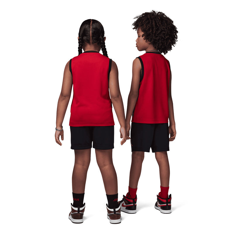 Back view of kids wearing red “Jordan 23” sleeveless tops with black shorts