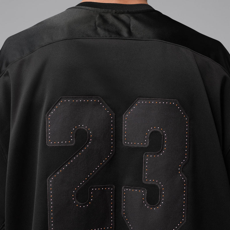 Men's black jersey back close-up with large stitched 23 number graphic