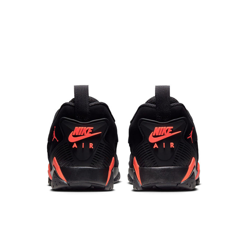 Back view of black sneakers with red-orange Nike Air heel logo, lace-up build