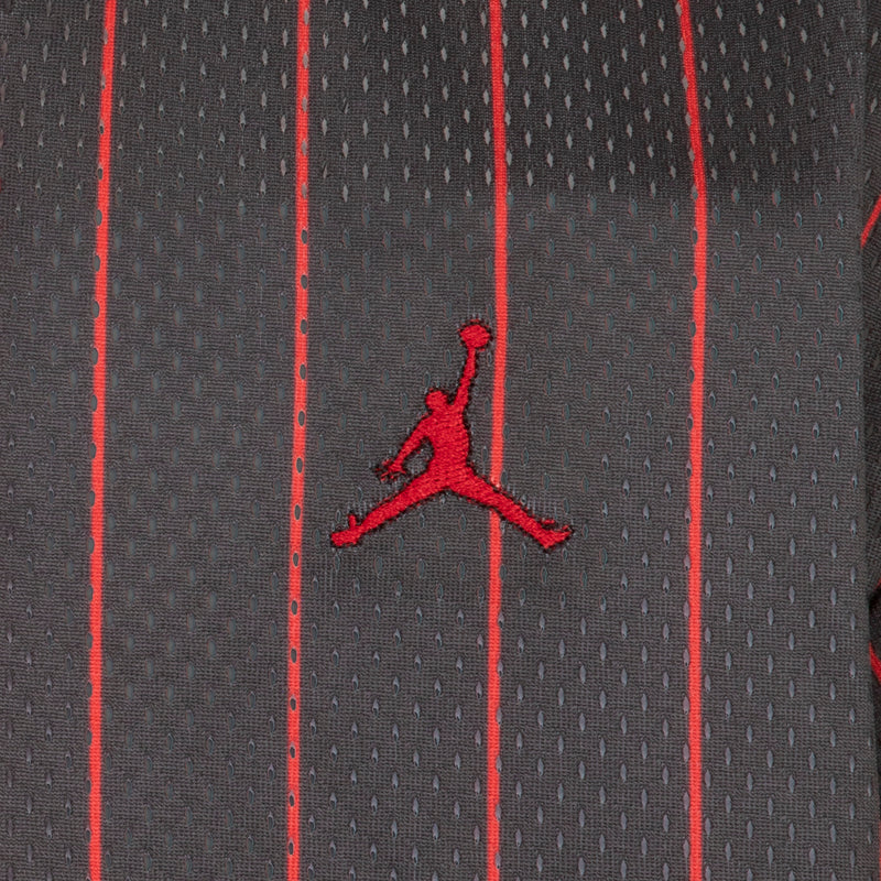 Youth jersey side panel with Jumpman silhouette logo on black striped fabric