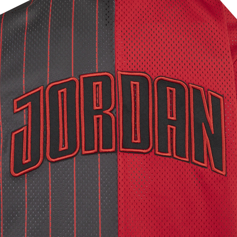 Youth jersey text detail: JORDAN outlined on dark with red background fabric