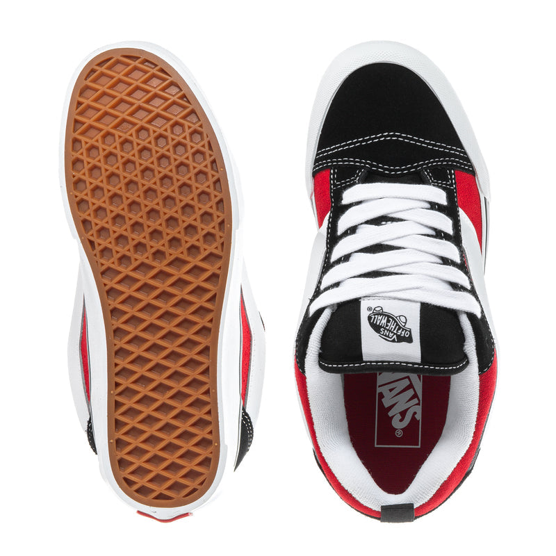 Youth sneakers: white sole with brown tread, black toe with red-and-white accents.