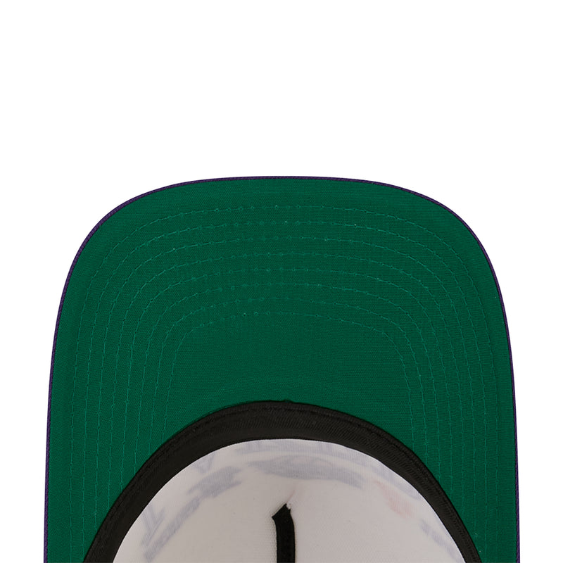 Green baseball cap with black inner rim and textured crown panel