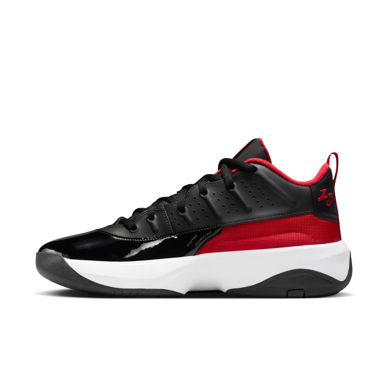 Men's black basketball shoe with red side stripe, lace-up upper and white midsole.