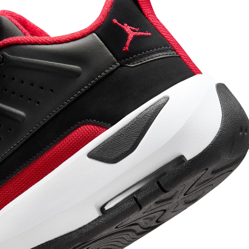 Men's black shoe close-up: red stripe and red Jumpman logo on the side, chunky sole.