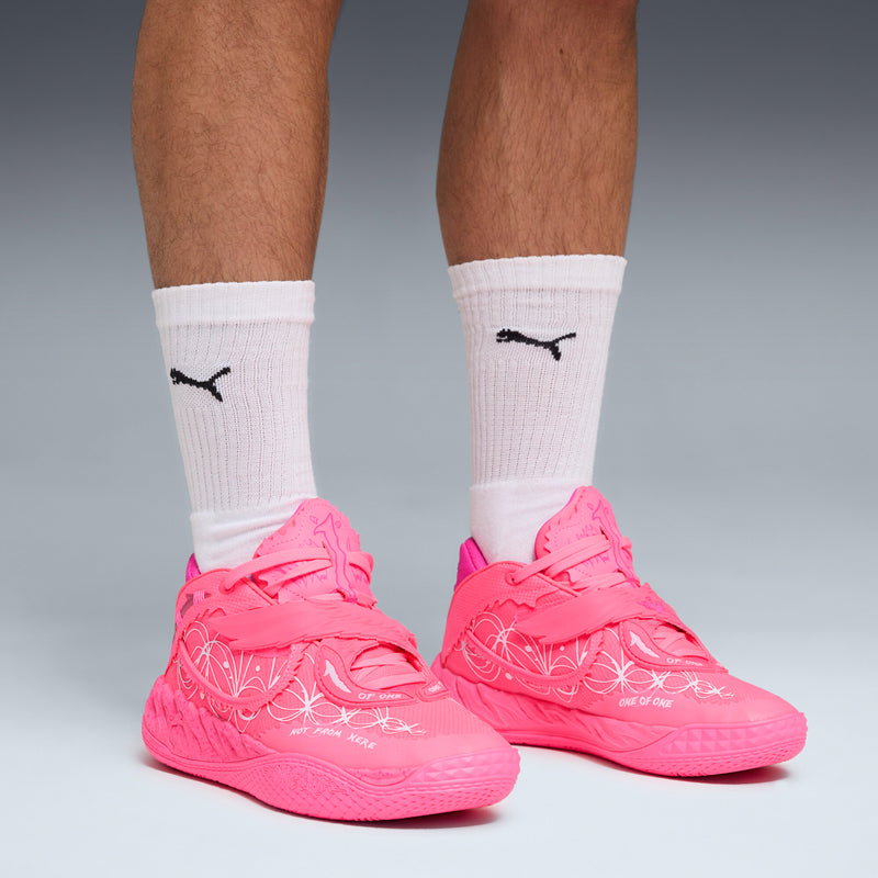 Pink low-top sneakers with white patterned side print; worn with crew socks.