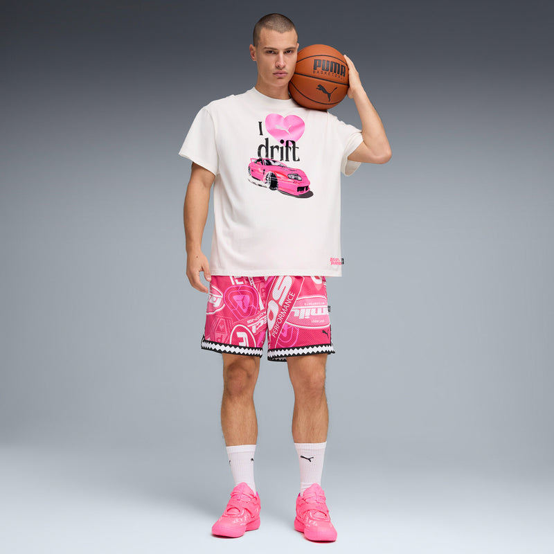 Pink low-top sneakers with white socks and matching graphic pink shorts.