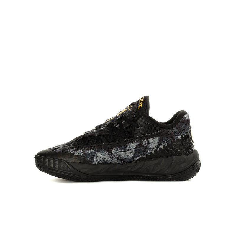 Youth black low-top sneaker with lace-up design and speckled side finish, yellow logo
