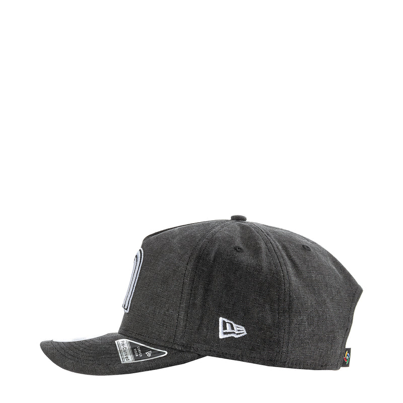 Washed black denim baseball cap with side New Era flag patch and logo