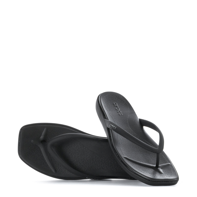 Pair of women's black flip-flops with molded footbed and slim thong straps