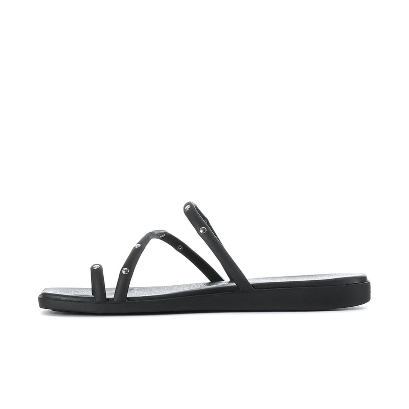 Black toe loop sandal with studded straps and flat slide sole, side view