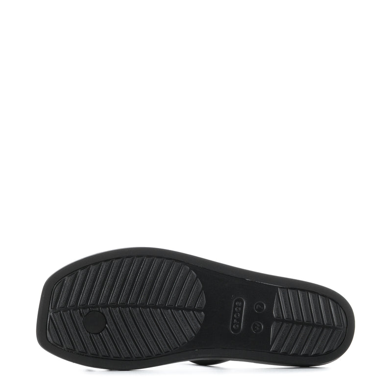 Black slide sandal outsole with textured tread and logo detail