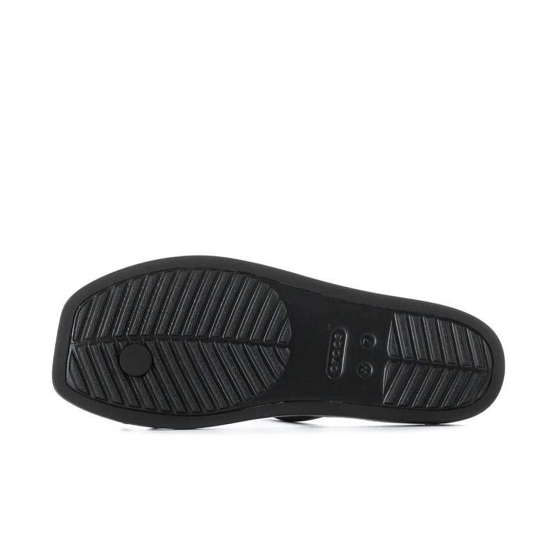 Black sandal outsole with textured tread pattern and toe loop strap
