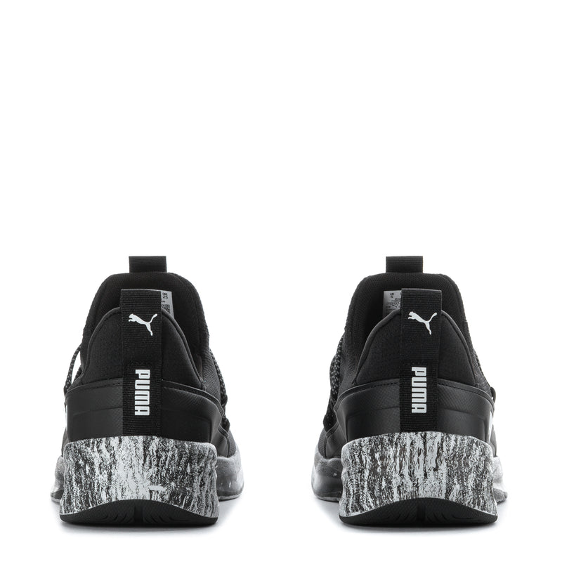 Black youth sneaker heel view with pull tab, PUMA branding, white speckled midsole