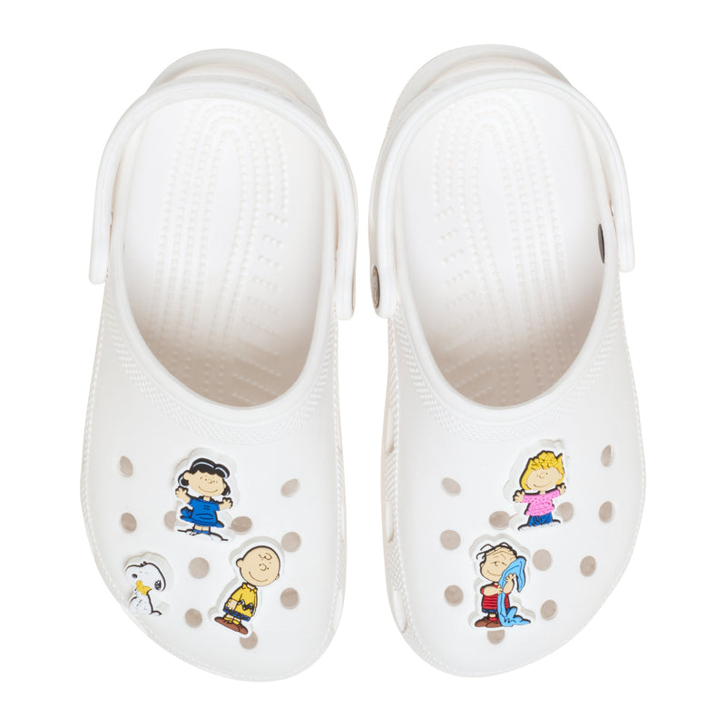 White clogs with Peanuts Jibbitz charms: Snoopy and Charlie Brown friends