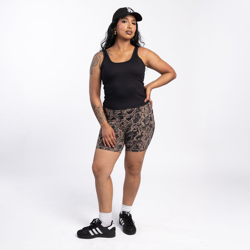 Women’s snake-print bike shorts worn with a black tank top