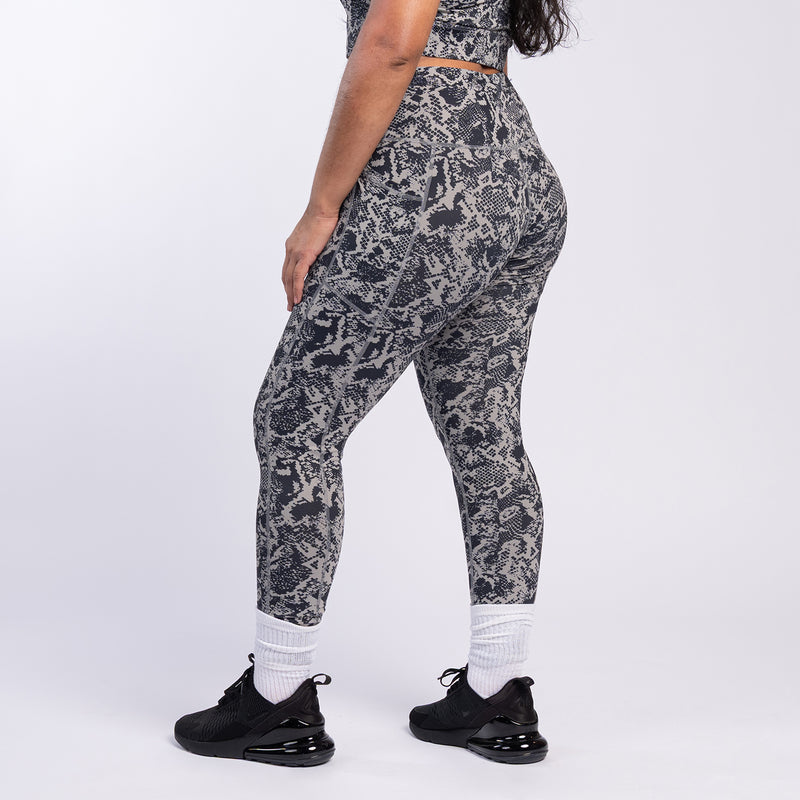 Front view of snake print high-waist leggings, dark gray and black