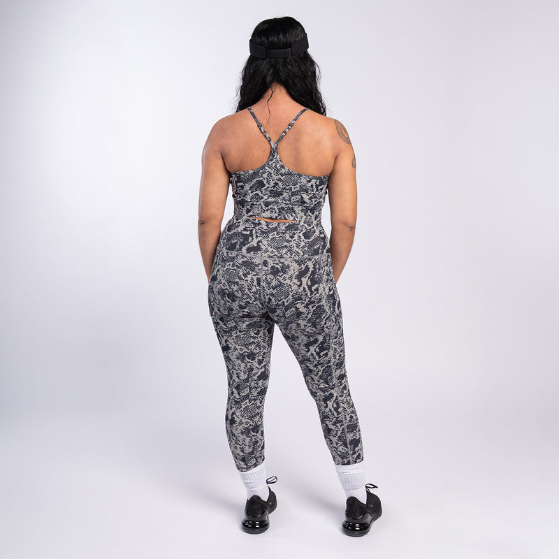 Back view of snake print high-waist leggings, dark gray and black allover