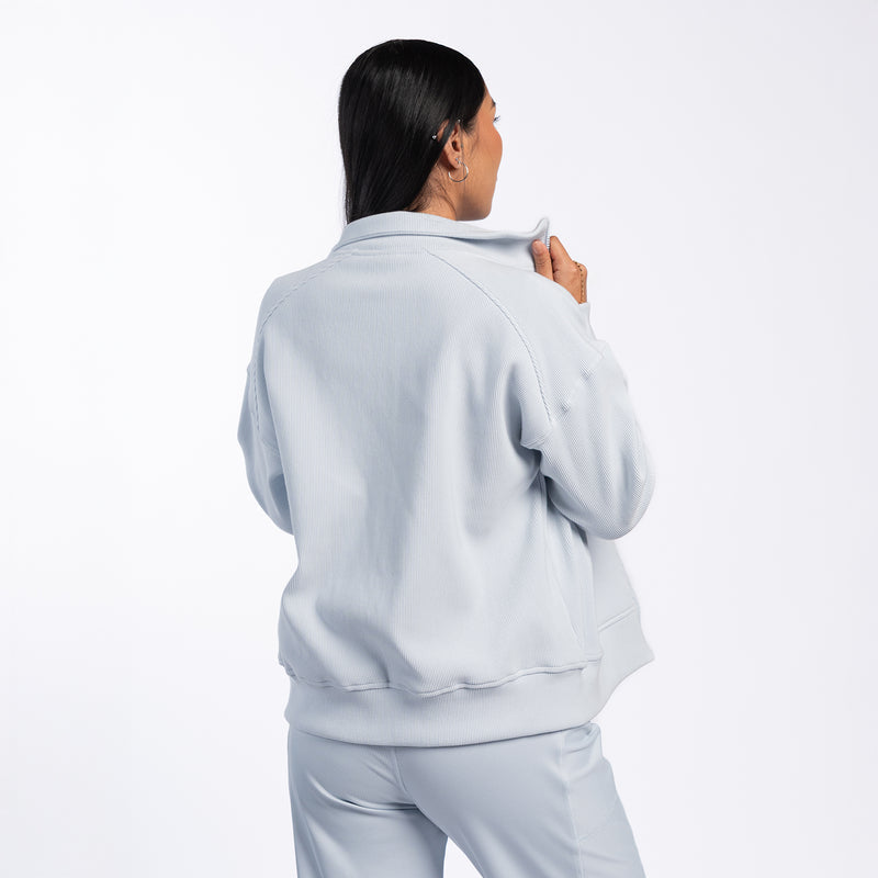 Light blue womens ribbed full-zip jacket, back view with hood and long sleeves