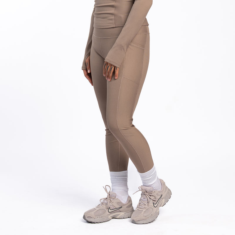 Women’s taupe grey ribbed leggings in side view with fitted knee and ankle seams