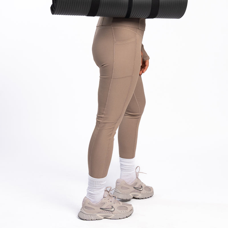 Taupe grey ribbed leggings side view with tapered leg and ankle-length hem