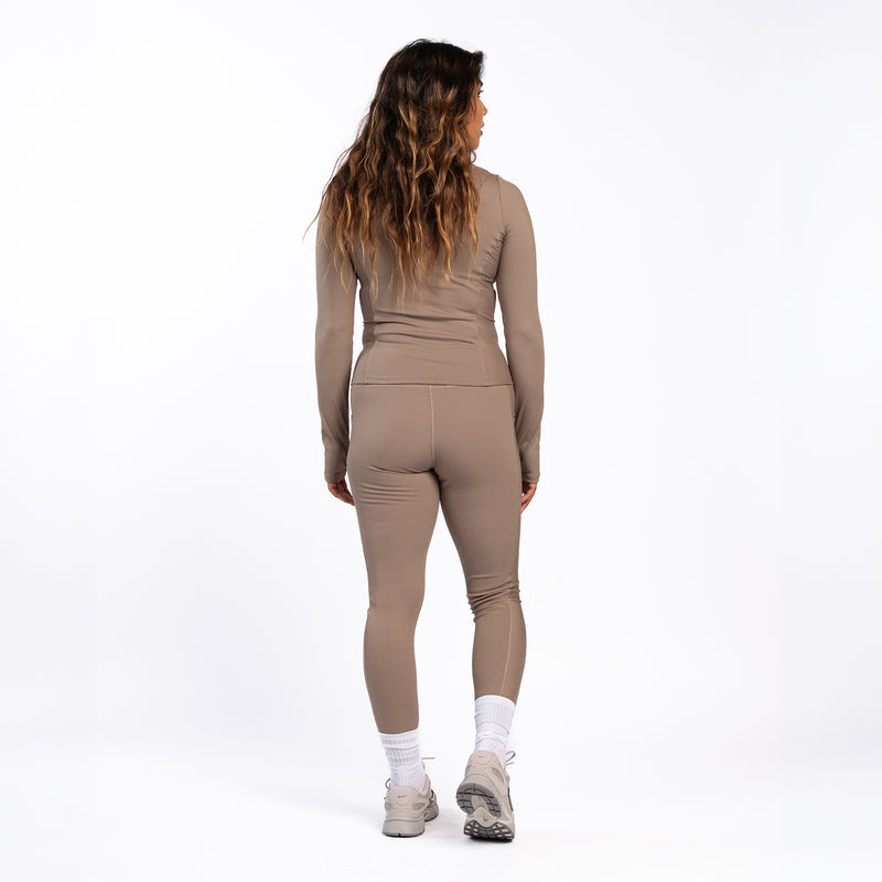 Women’s taupe grey ribbed leggings seen from back with high-rise waistband fit