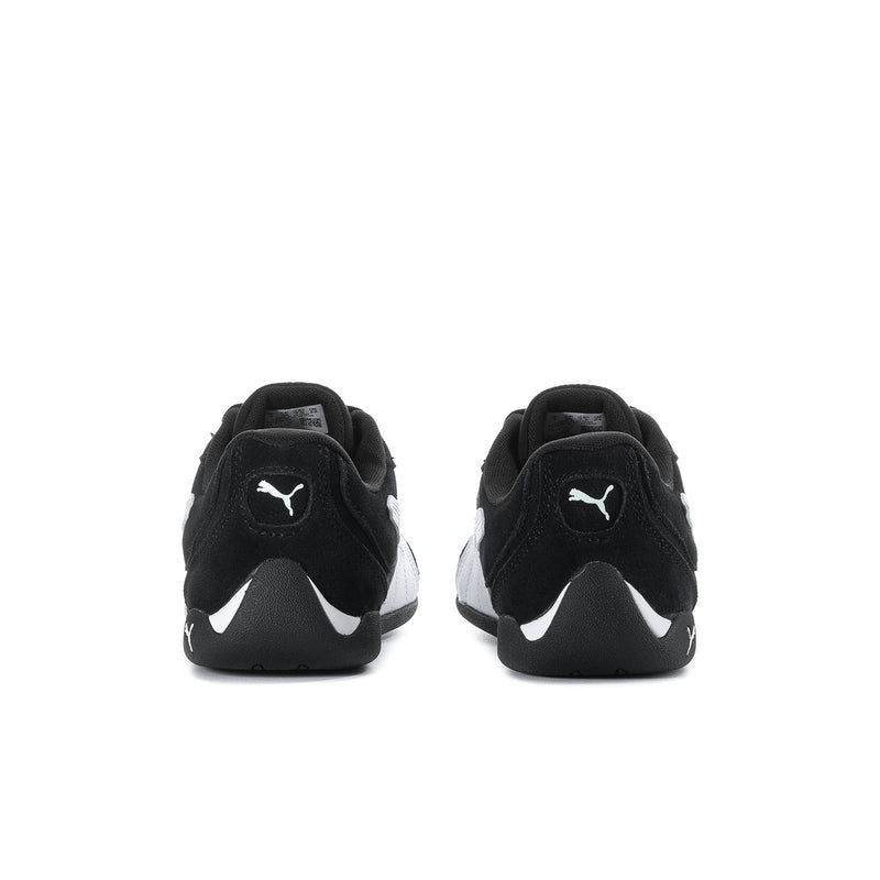 Women's black low-top sneakers with PUMA logo at back, heel view