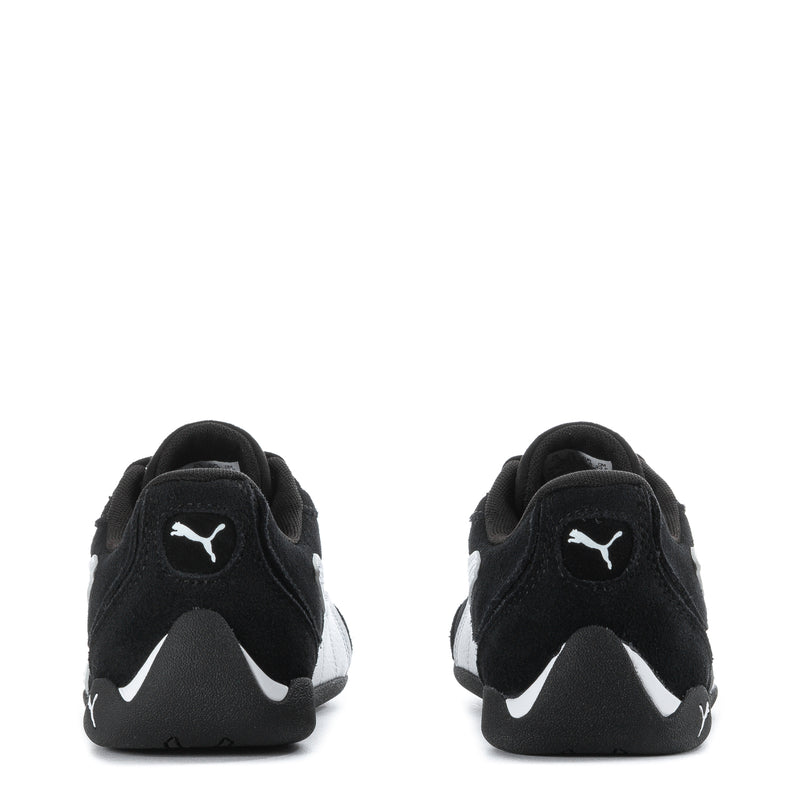 Youth black Puma suede sneakers, heel view with white logo accents