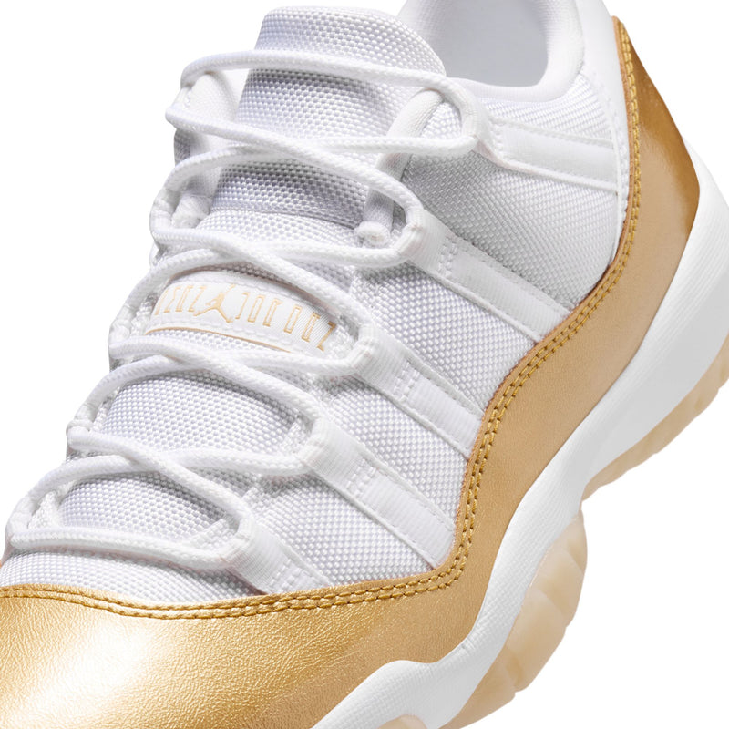 Close-up of white mesh sneaker with gold quarter panel and lace-up vamp