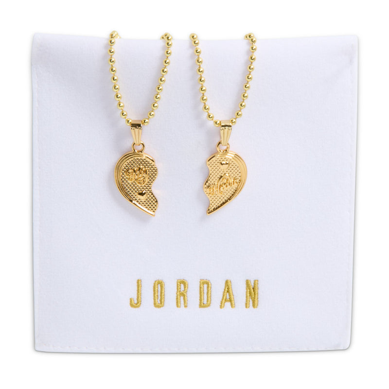 Gold-tone pendant necklace set on a card with two matching heart pendants
