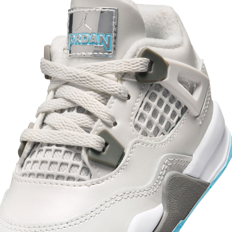 Toddler white sneaker detail with JORDAN label, gray net panel, and blue trim