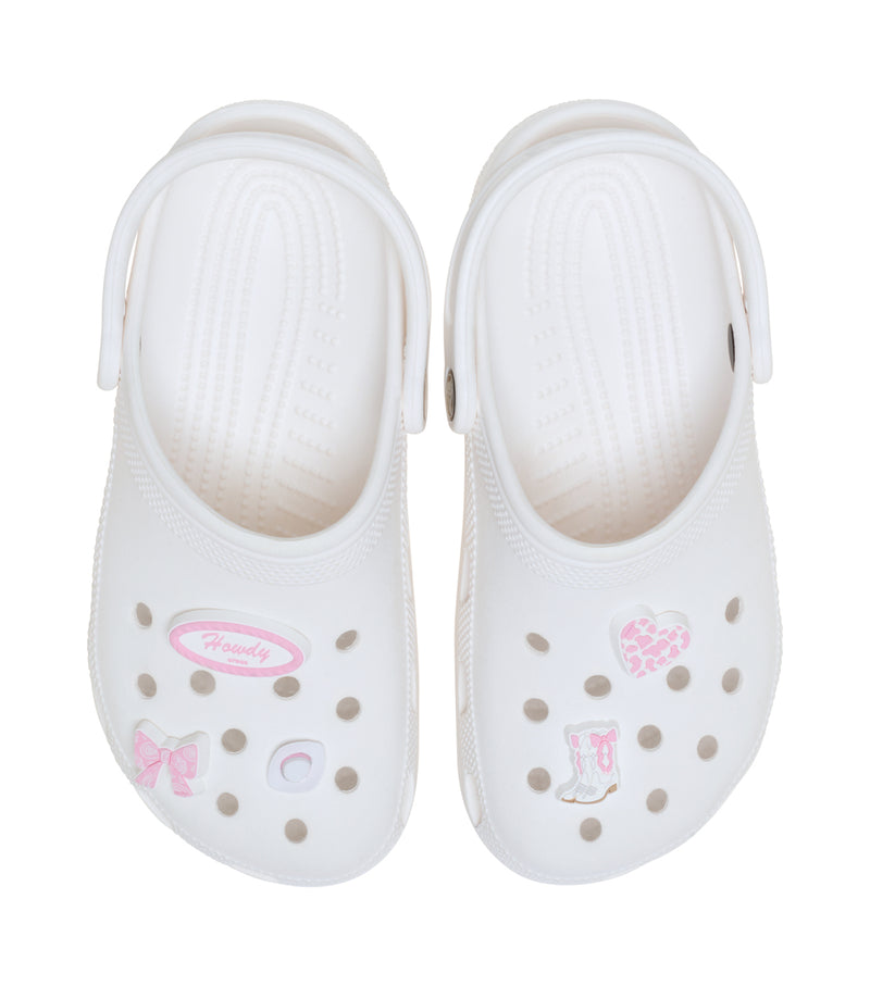 White clog with pink rodeo cowgirl Jibbitz charms: bow, heart, hat, Howdy oval, star