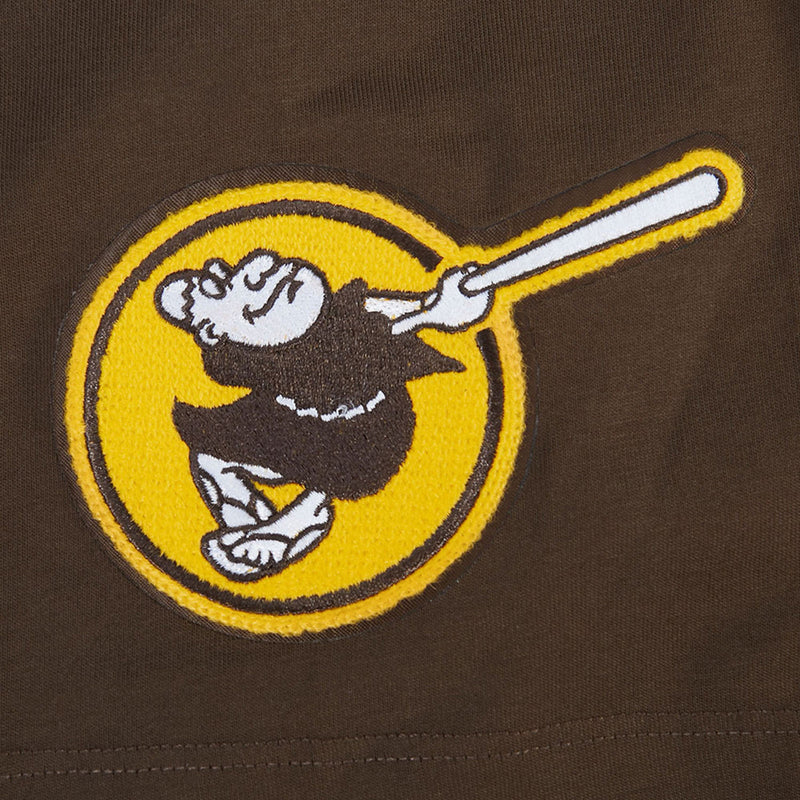 Men's brown tee sleeve patch with yellow circle mascot and white bat