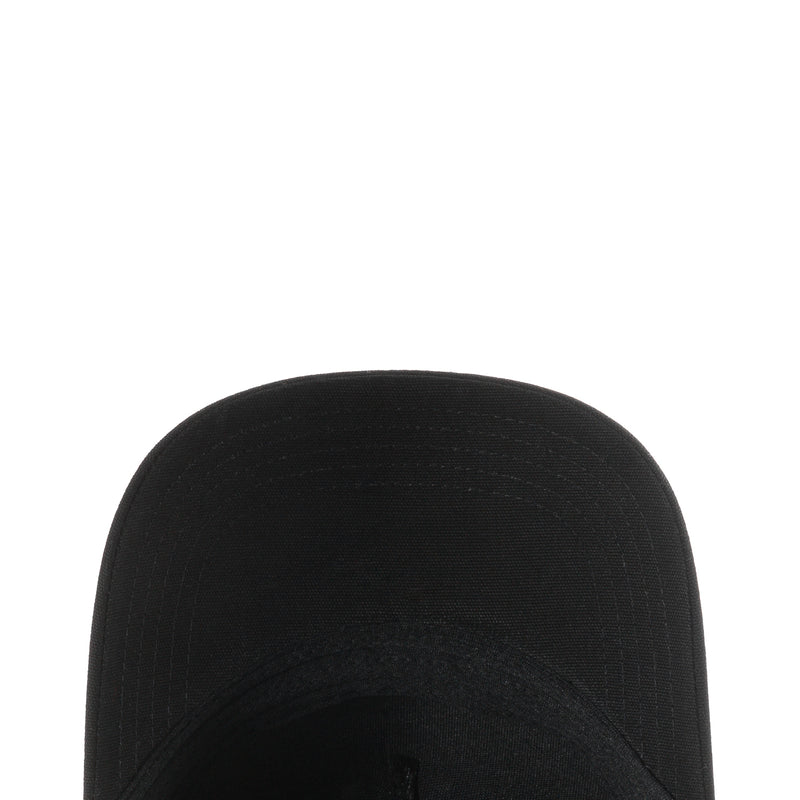 Black trucker cap crown close-up with stitched seam and raised panel