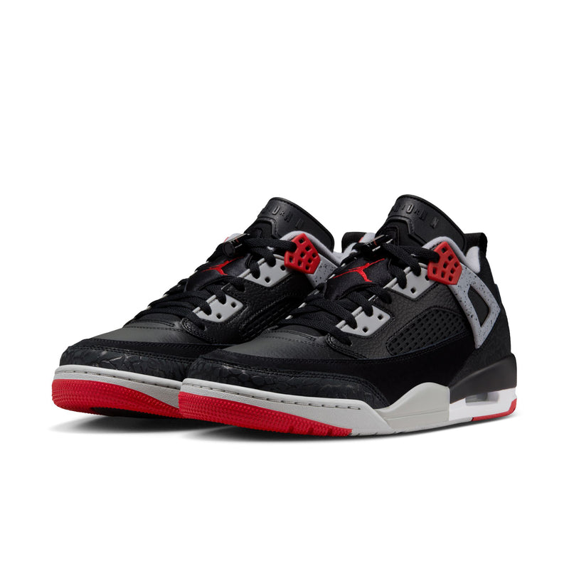 Pair of men's low-top sneakers, black uppers with white details and red soles