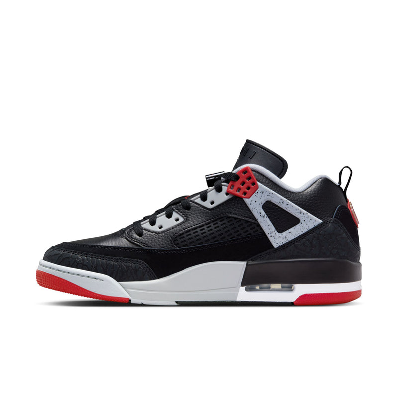 Men's low-top sneakers in black with white side paneling and red outsole trim
