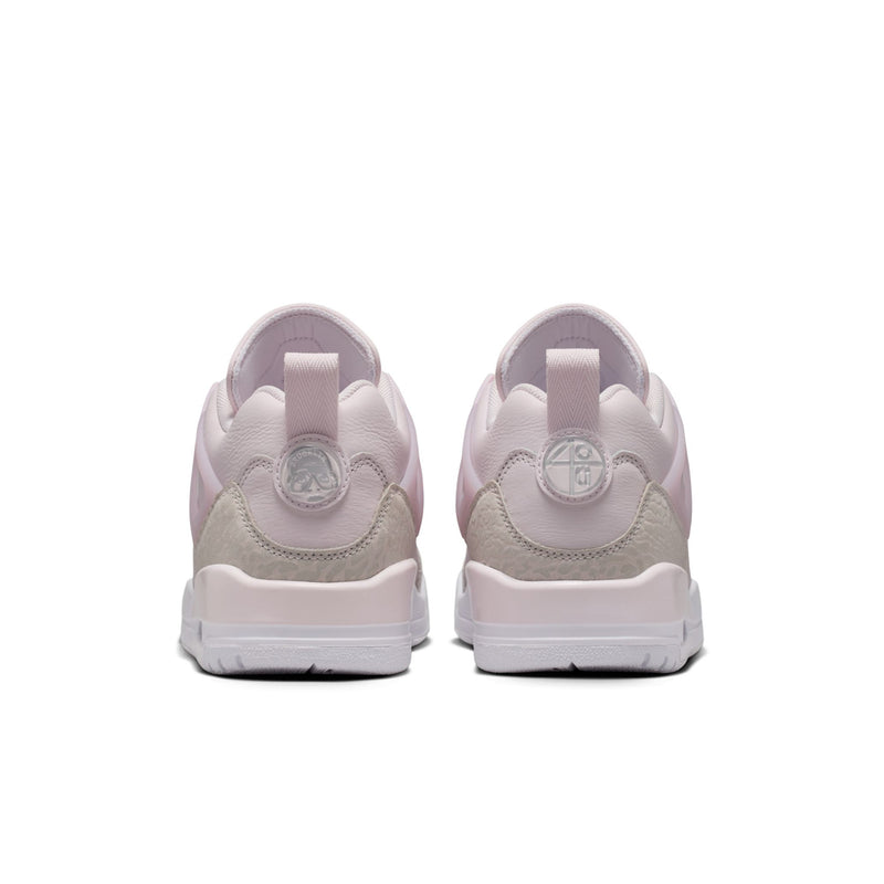 Women’s pearl pink low-top sneakers from heel view with cushioned back and logo tabs