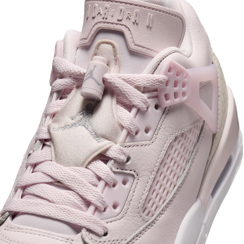 Close-up of women’s pearl pink low-top sneaker upper with lace and tongue branding