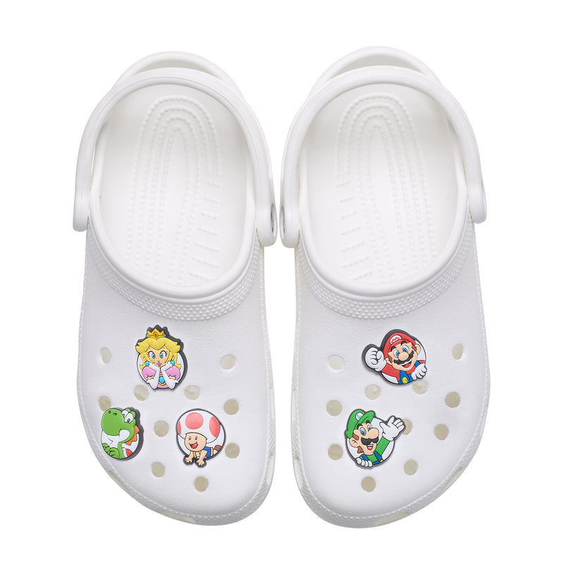 White clogs with Super Mario character Jibbitz charms on the front holes
