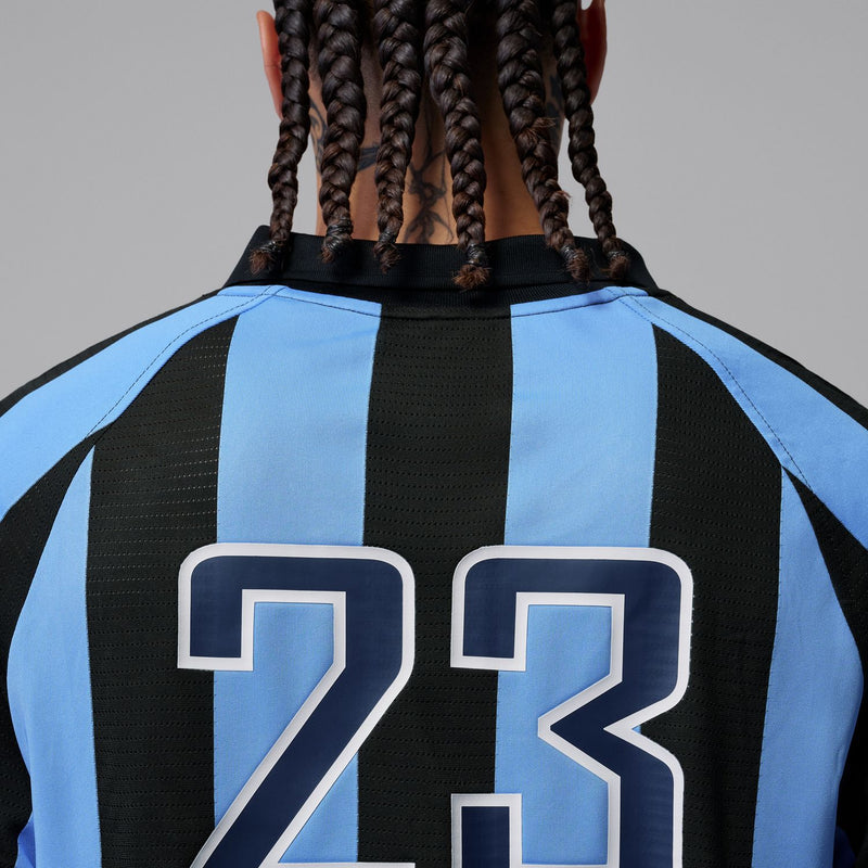 Jersey back close-up showing large 23 print on blue-and-black stripes