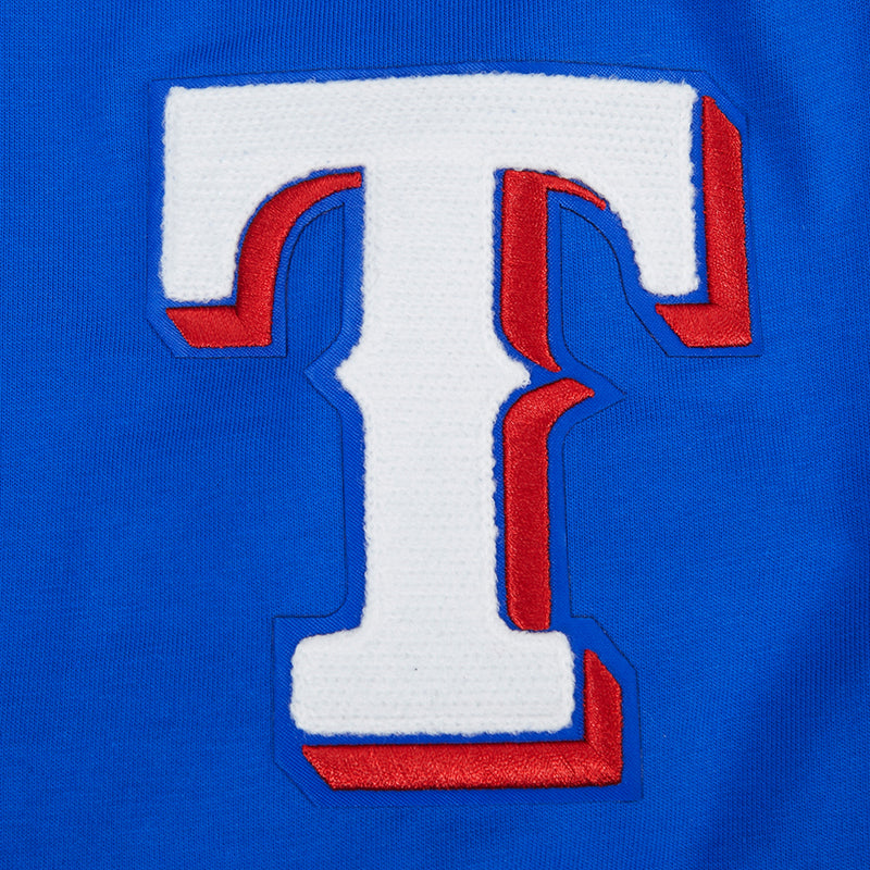Men's royal blue T-shirt close-up of white-and-red T emblem with blue outline