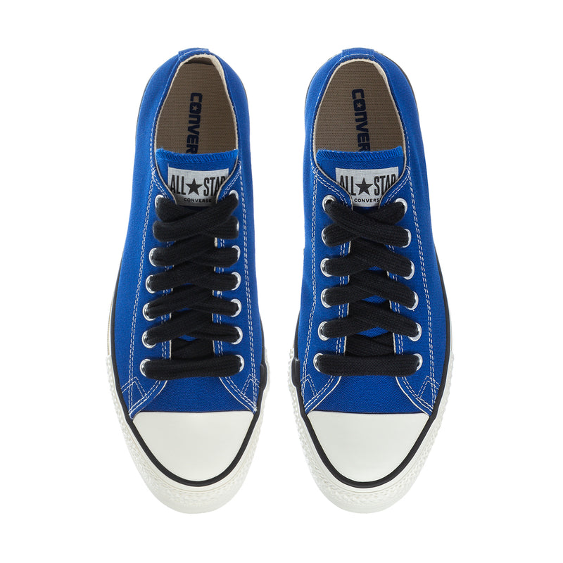 Blue low-top sneakers front view with black laces and “Converse” tongue branding