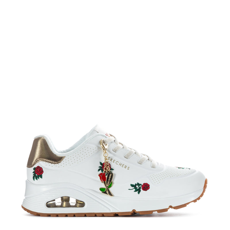 White women's sneaker with gold collar, red rose patches, lace-up, gum rubber sole