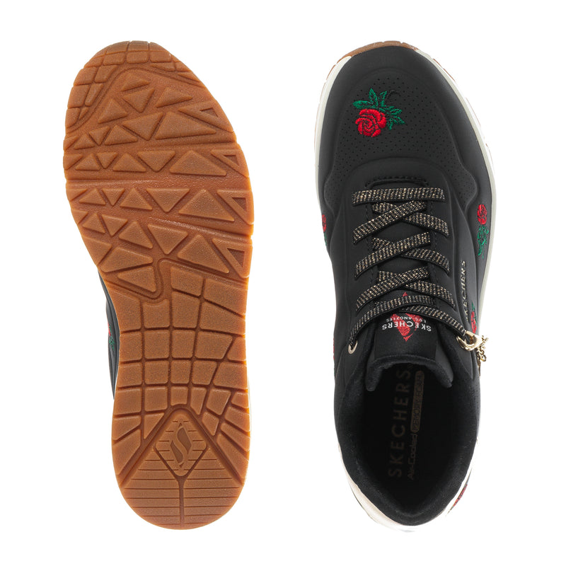 Black sneaker sole and inside view, rose accents, brown tread rubber outsole