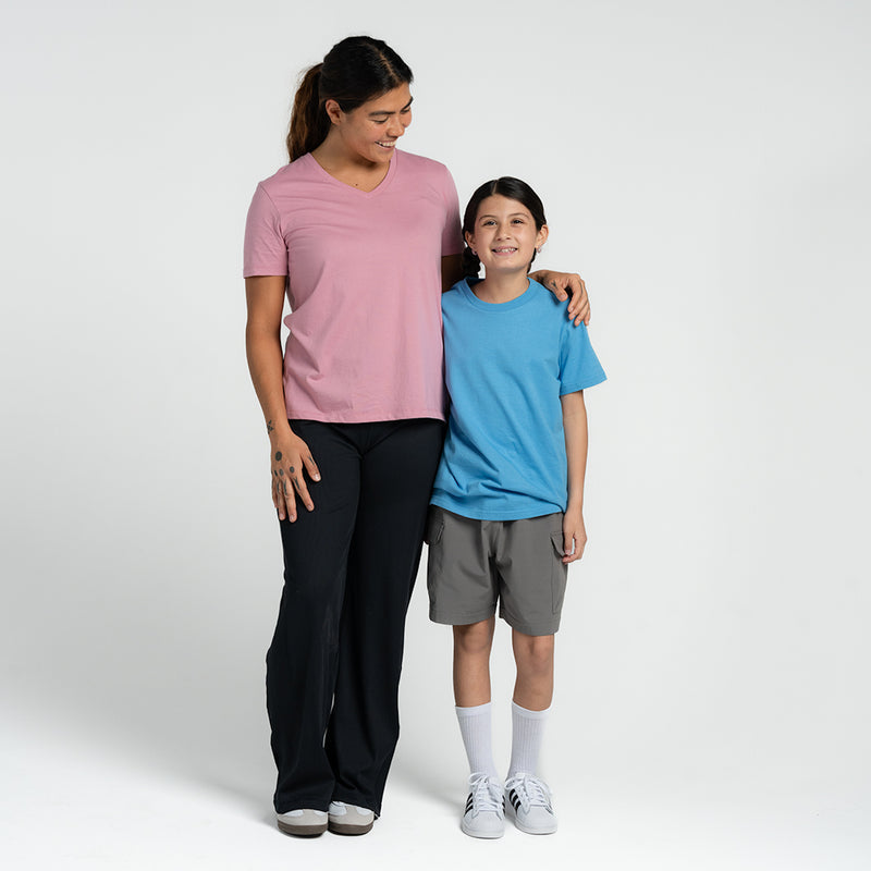 Women's rose pink V-neck short-sleeve tee on model, solid knit