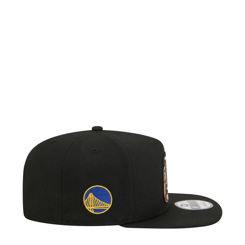 Black snapback cap side view with blue Warriors logo patch