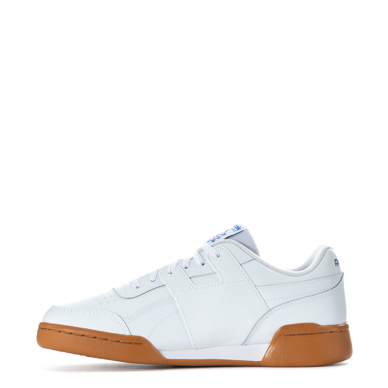 White youth Reebok lace-up sneaker with gum midsole and side panel stitching.