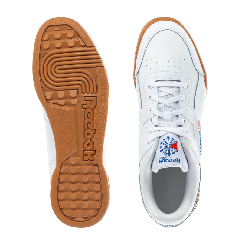 White youth Reebok sneaker with brown gum outsole tread; heel and toe views.